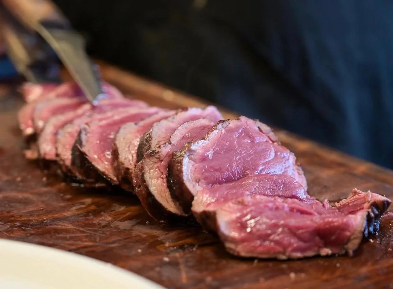 Sliced beef on a wooden board